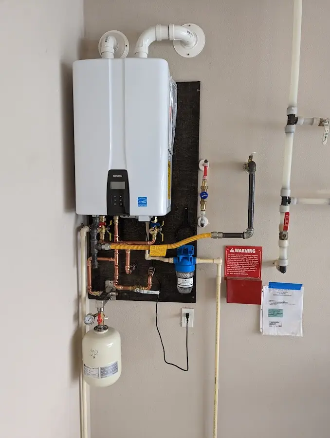 Professional plumber installing copper piping in a Circle D-KC Estates home